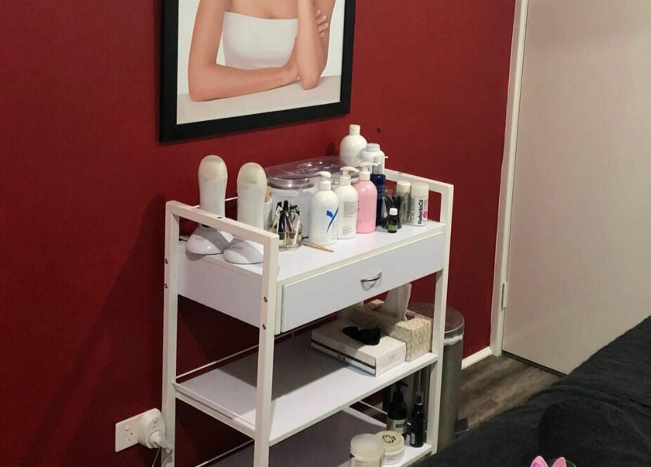 Northern Beauty Bullsbrook treatment room with red walls, skincare products, Bullsbrook, Western Australia, AU.