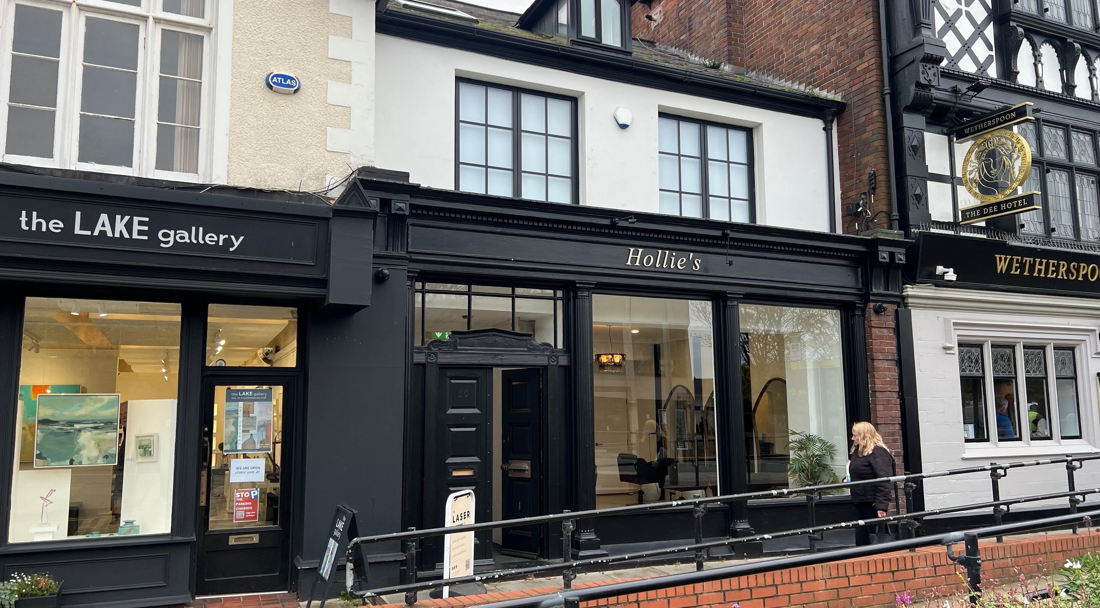 Exterior of Face Philosophy at West Kirby, England, GB, showcasing elegant black storefront design.