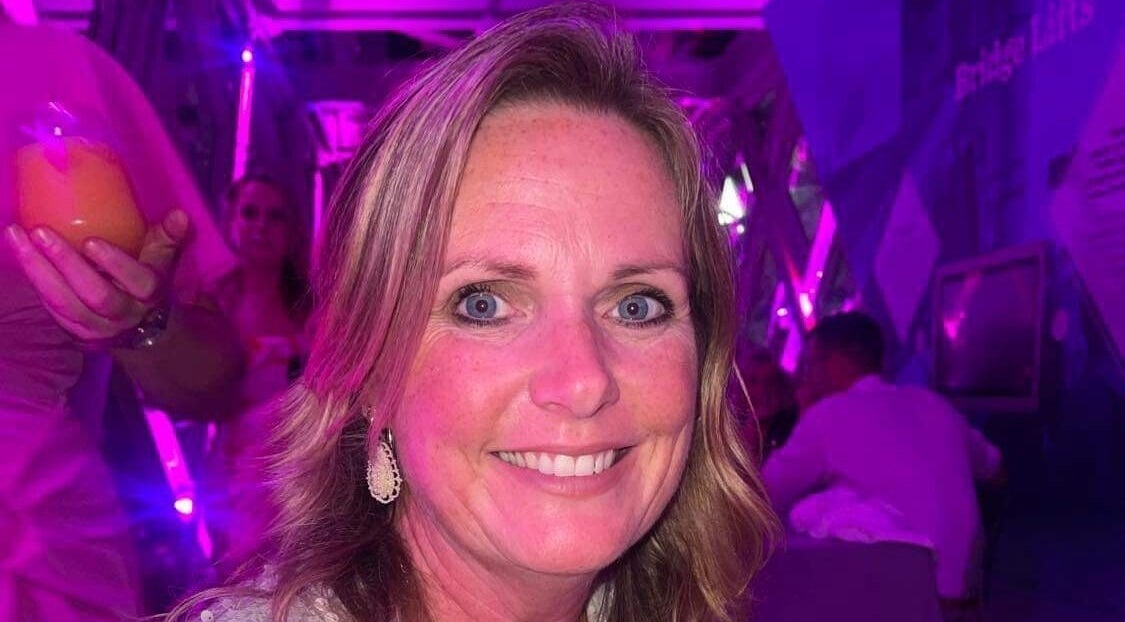 Smiling guest at The 121 Diet by Cambridge Weight Plan with Vanessa, UK, UK, GB in a lively, pink-lit setting.