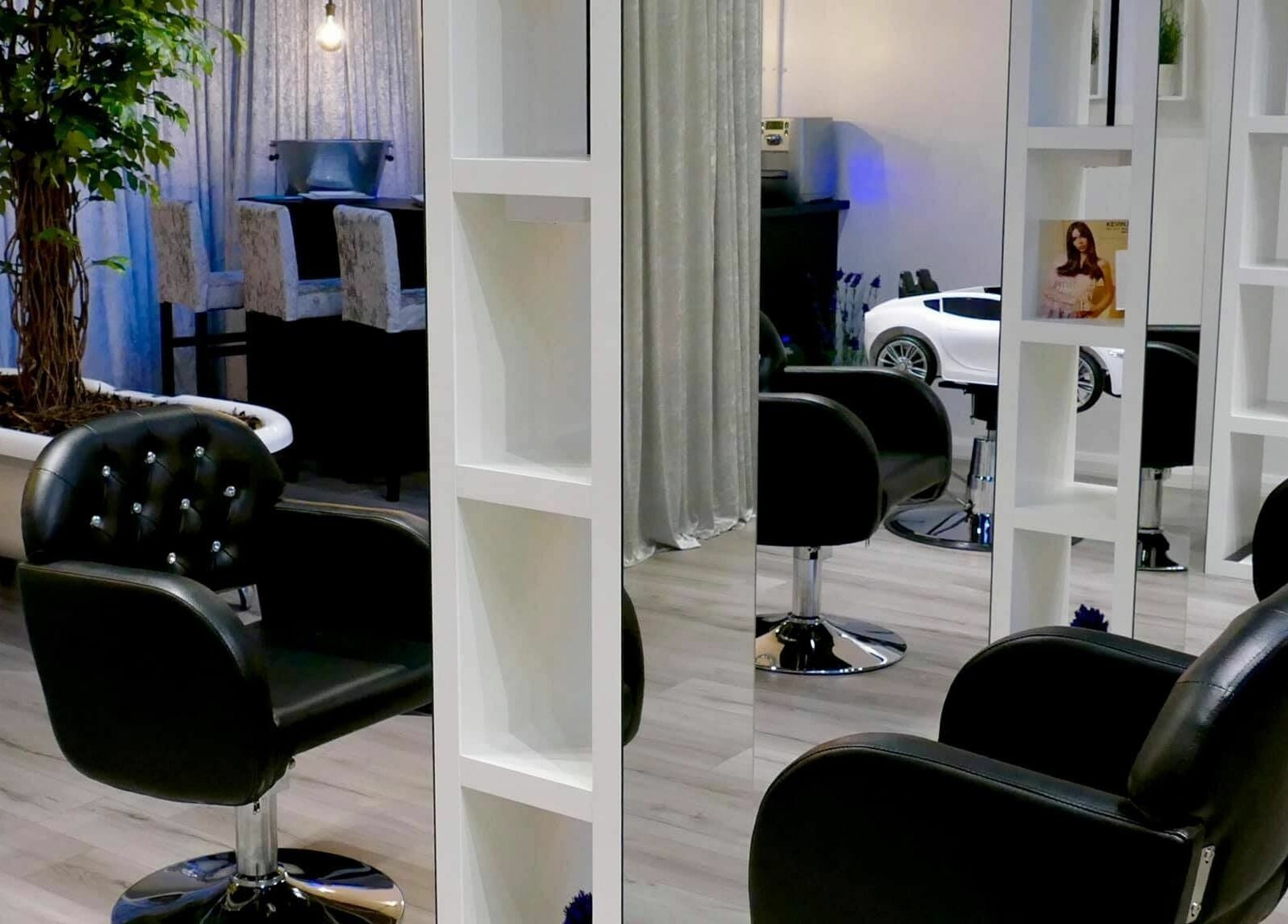 Stylish salon interior at The Salt Room, Sowerby Bridge, England, GB with elegant black chairs and mirrors.