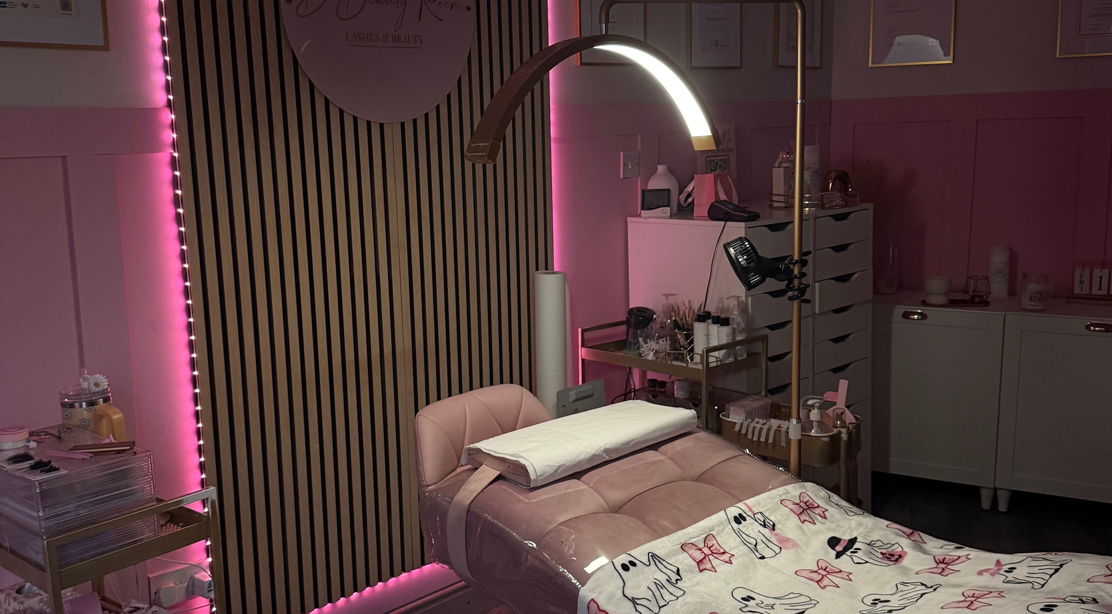 Elegant treatment room at D Beauty Room, Laytown, IE with modern decor and pink accents.