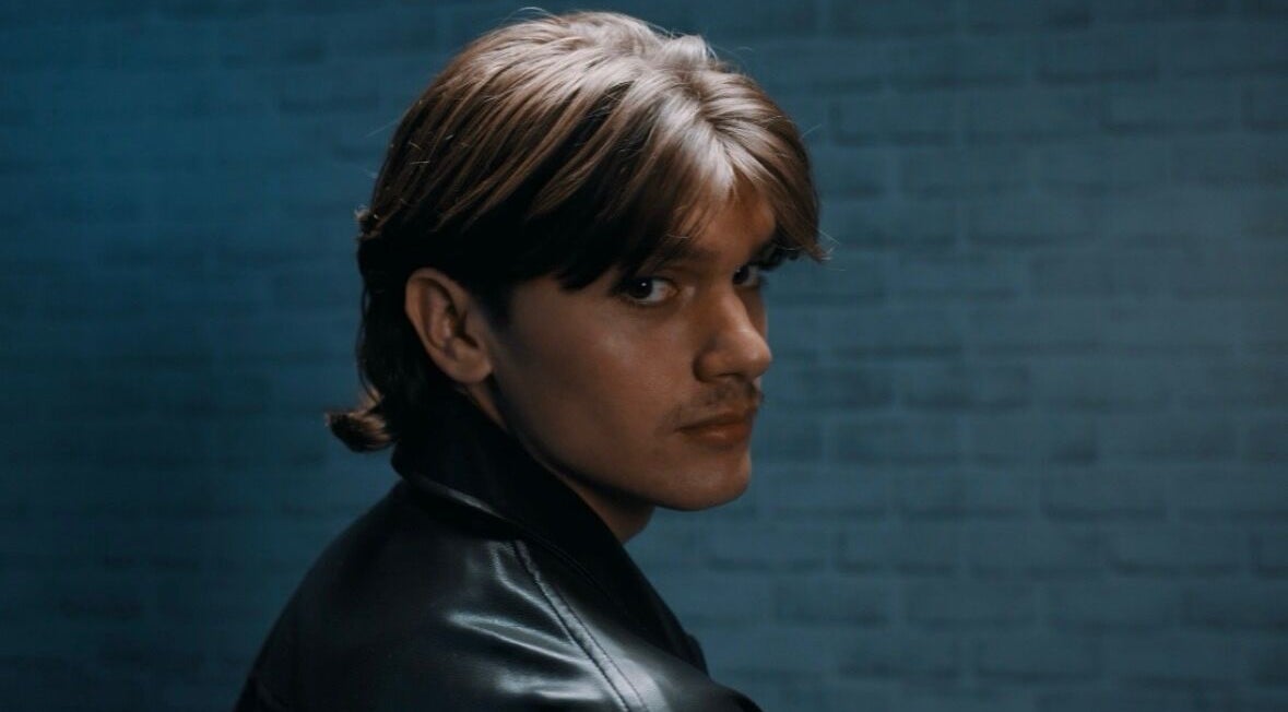 Chic hairstyle model at Terribile Barber Shop in Birkirkara, MT with a sleek leather jacket.