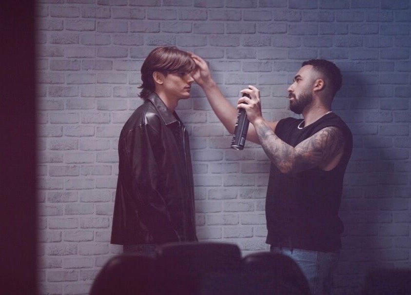 Stylist applying hair spray at Terribile Barber Shop in Birkirkara, MT, capturing modern grooming techniques.
