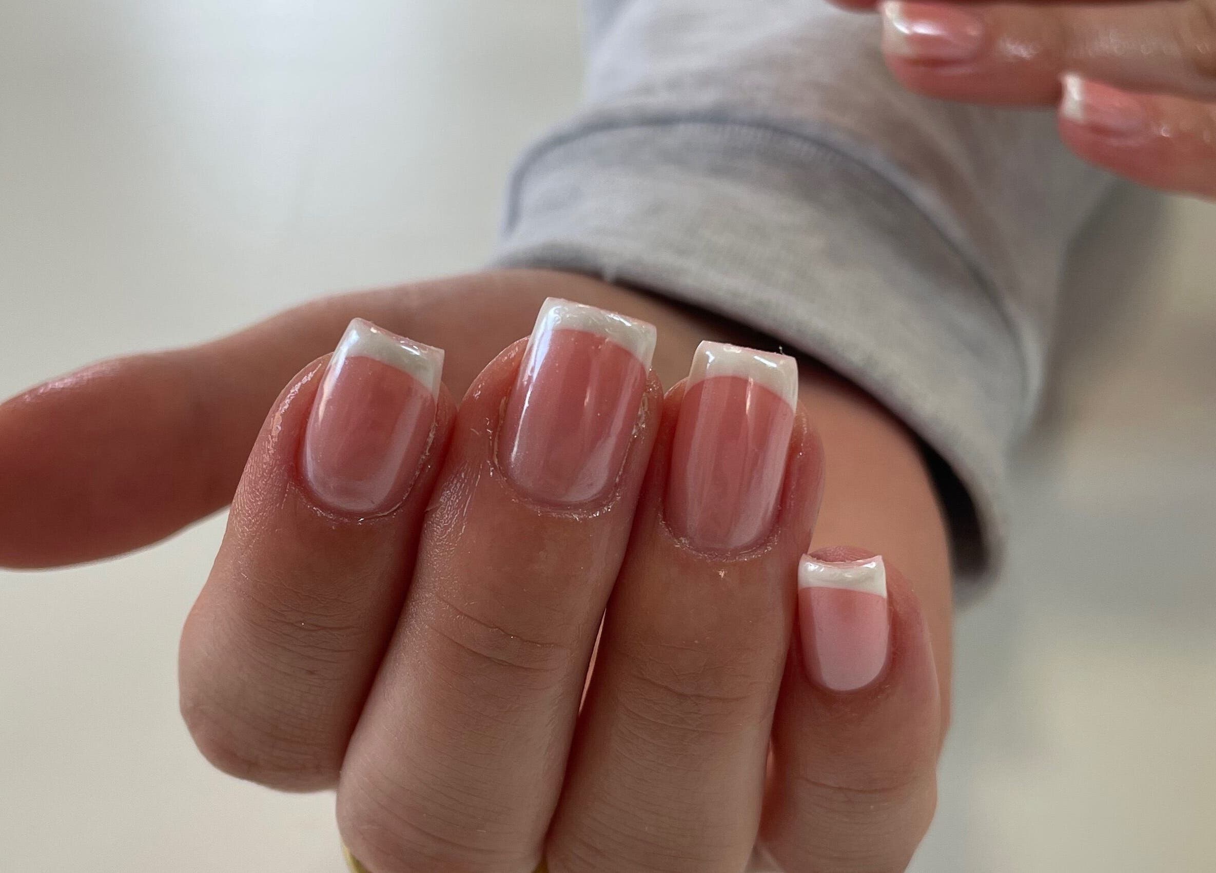 Beautiful French manicure at Nails By Lois in Glasgow, Scotland, GB showcasing polished elegance.