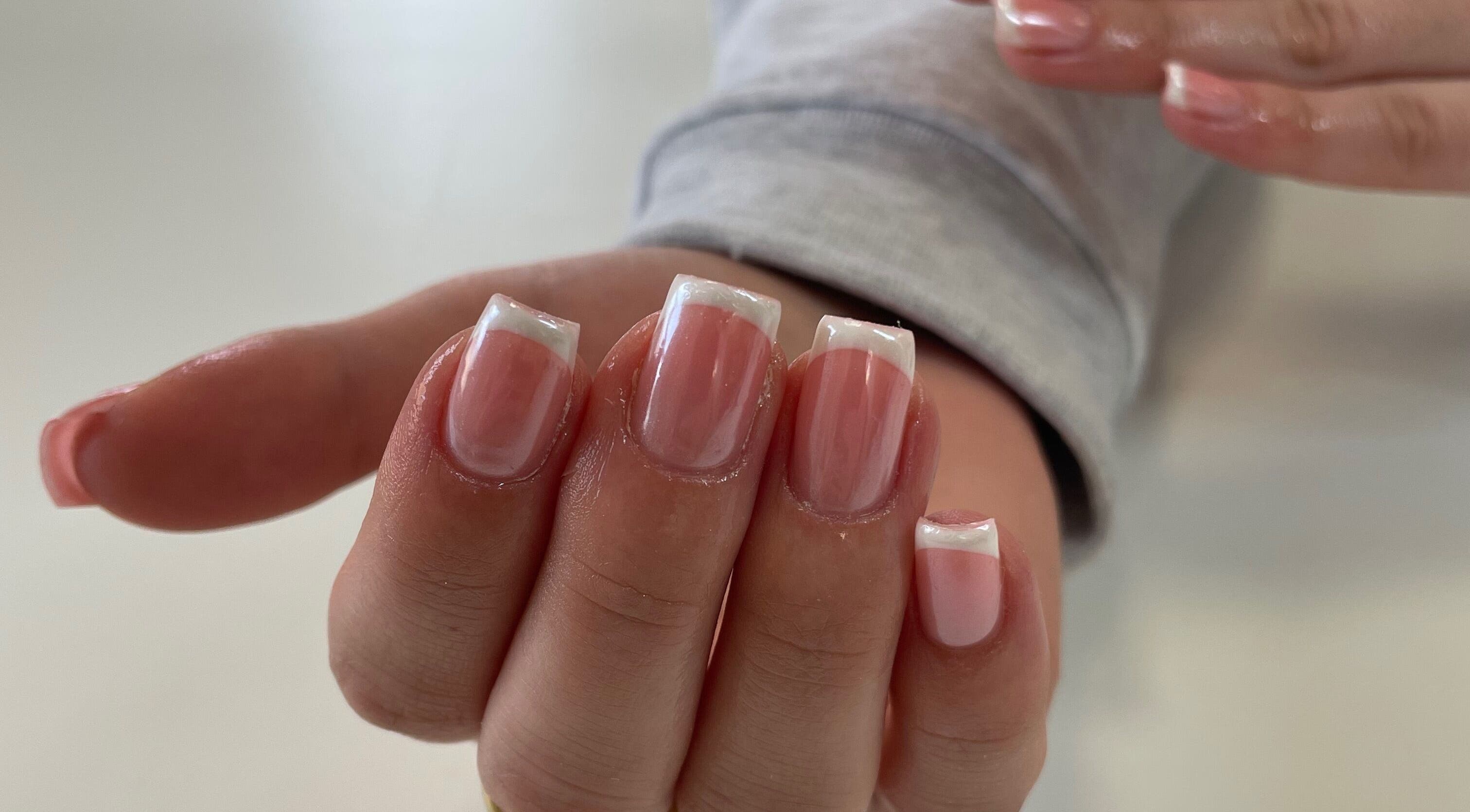 Beautiful French manicure at Nails By Lois in Glasgow, Scotland, GB showcasing polished elegance.