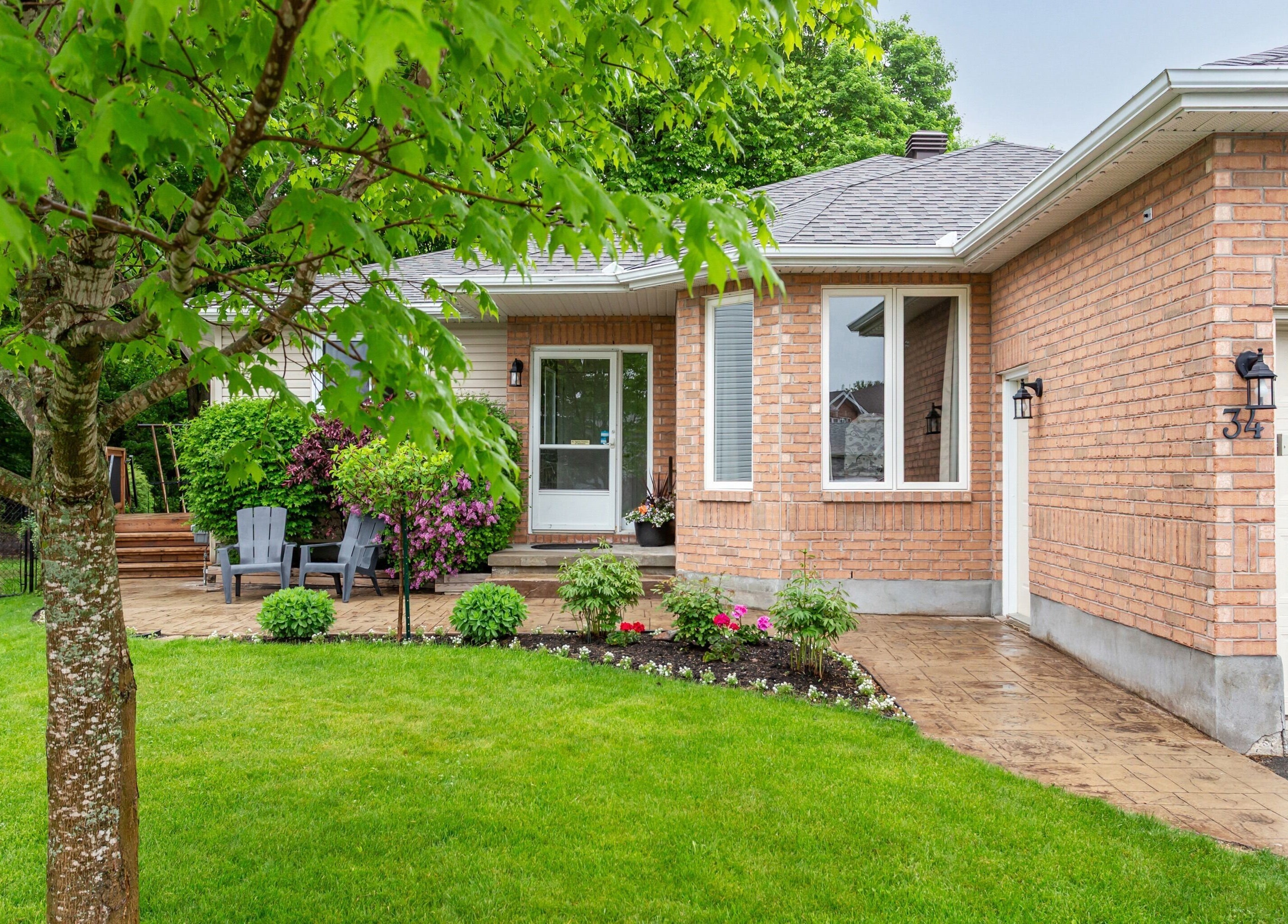 Inviting exterior of STUDIODERMA in Ottawa, Ontario, CA, featuring lush landscaping and a cozy entrance.
