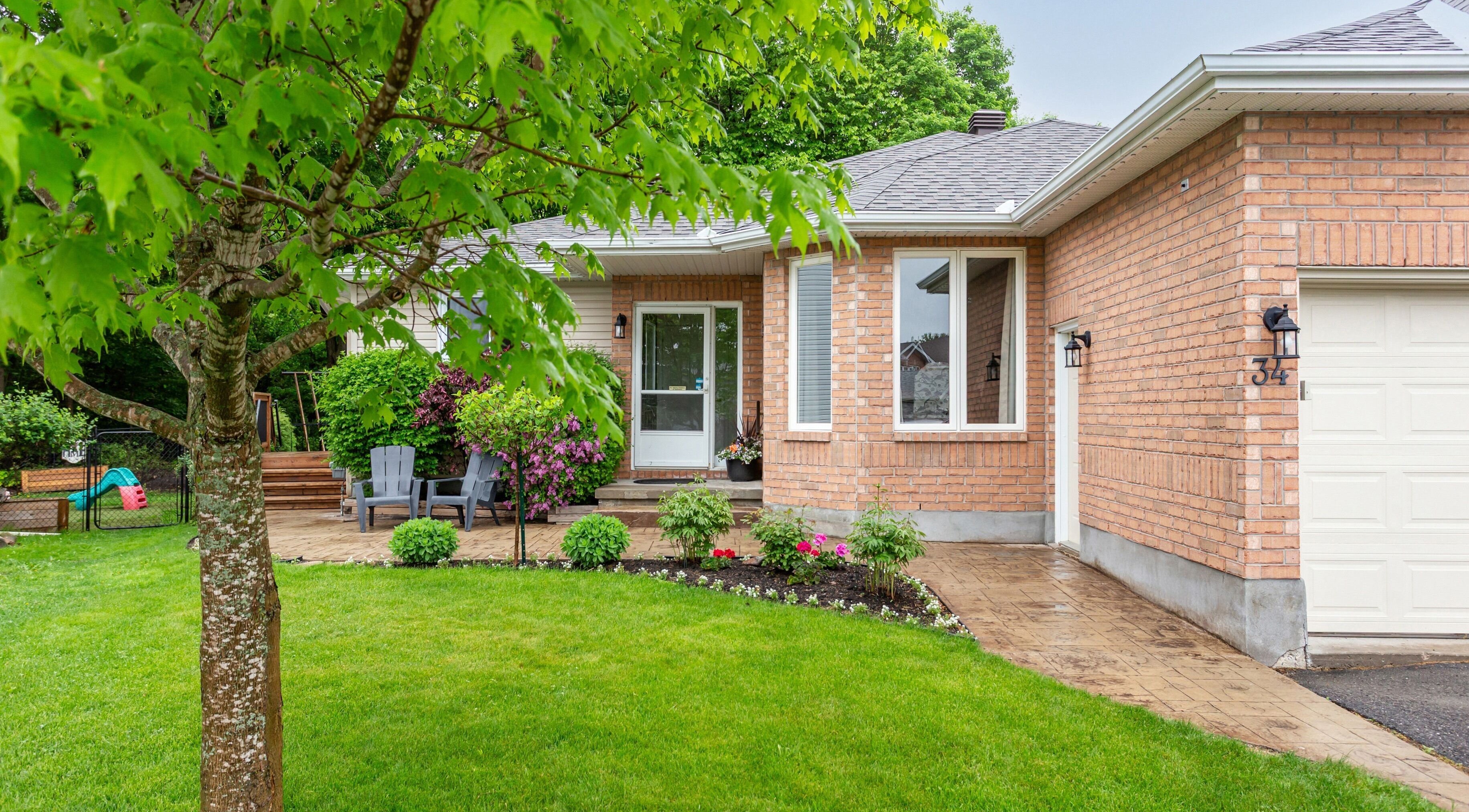 Inviting exterior of STUDIODERMA in Ottawa, Ontario, CA, featuring lush landscaping and a cozy entrance.