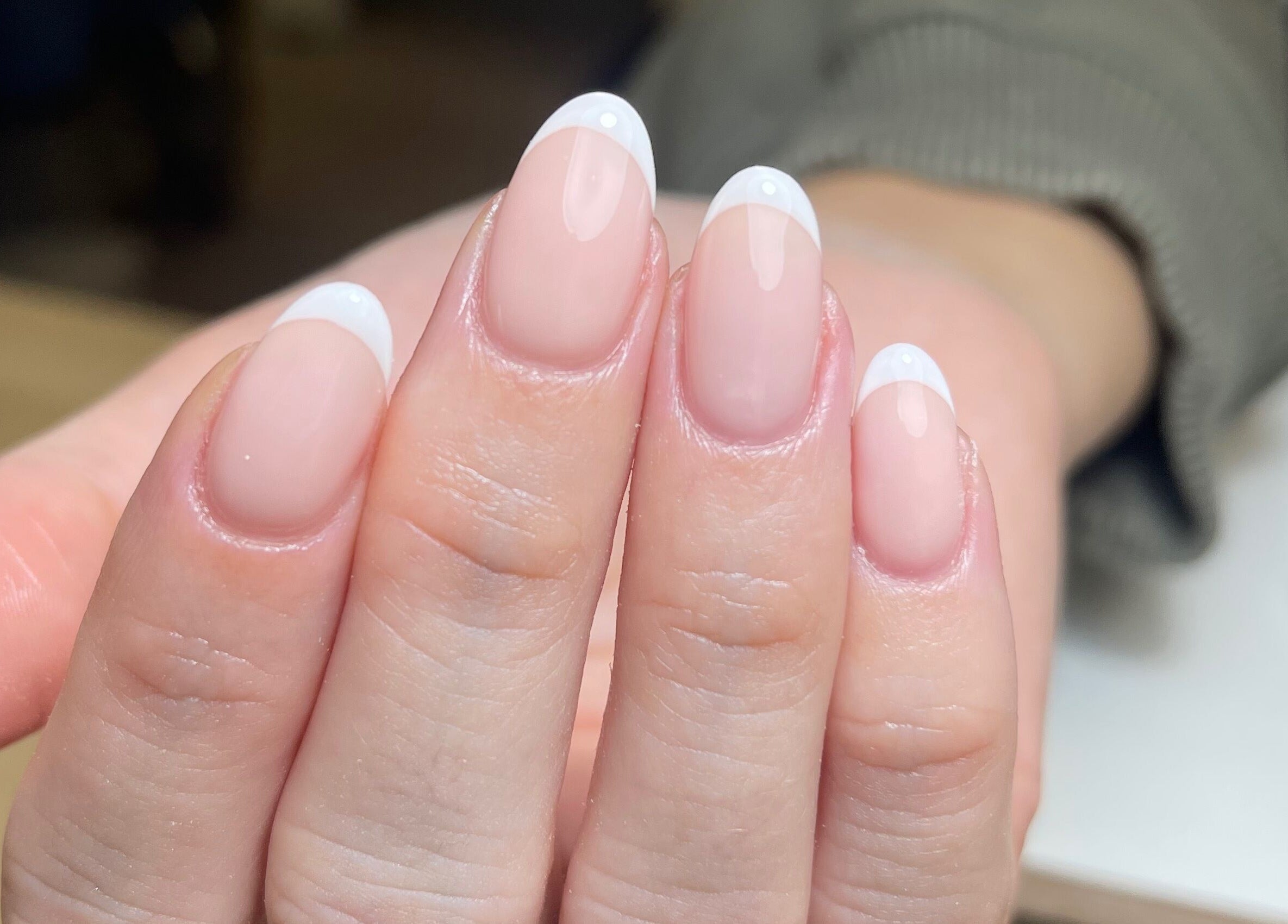 Elegant French manicure nails at By Demi, Belfast, Northern Ireland, GB, showcasing natural beauty.