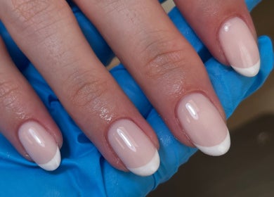 French manicure at By Demi, Belfast, Northern Ireland, GB. Elegant pink nails with white tips enhance your style.