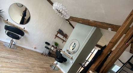 Modern, cozy interior of The Hair Studio in Sudbury, England, GB, featuring stylish seating and chic decor.
