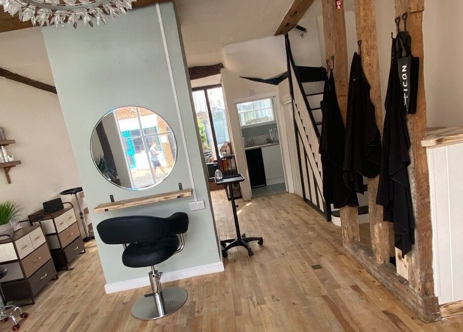 Chic interior design at The Hair Studio, Sudbury, England, GB with stylist areas and rustic decor.