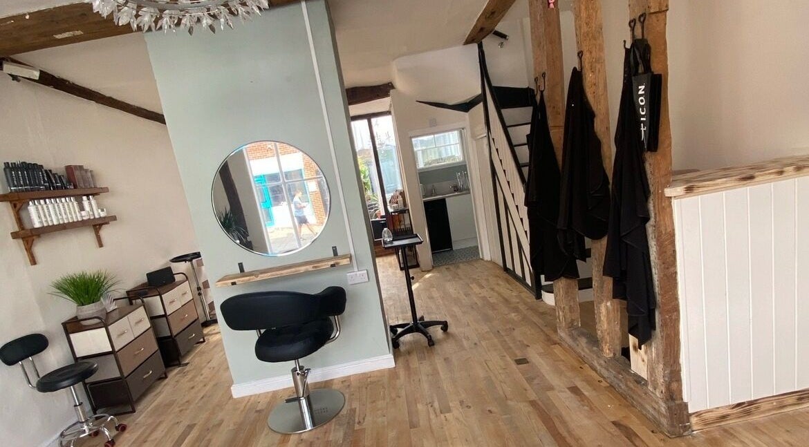Chic interior design at The Hair Studio, Sudbury, England, GB with stylist areas and rustic decor.
