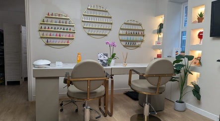 Chic manicure station at Aesthetically Yours, Poynton, England, GB with decor and nail polish display.