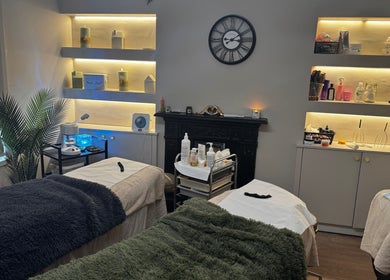 Calming treatment room at Aesthetically Yours, Poynton, England, GB with cozy beds and ambient lighting.