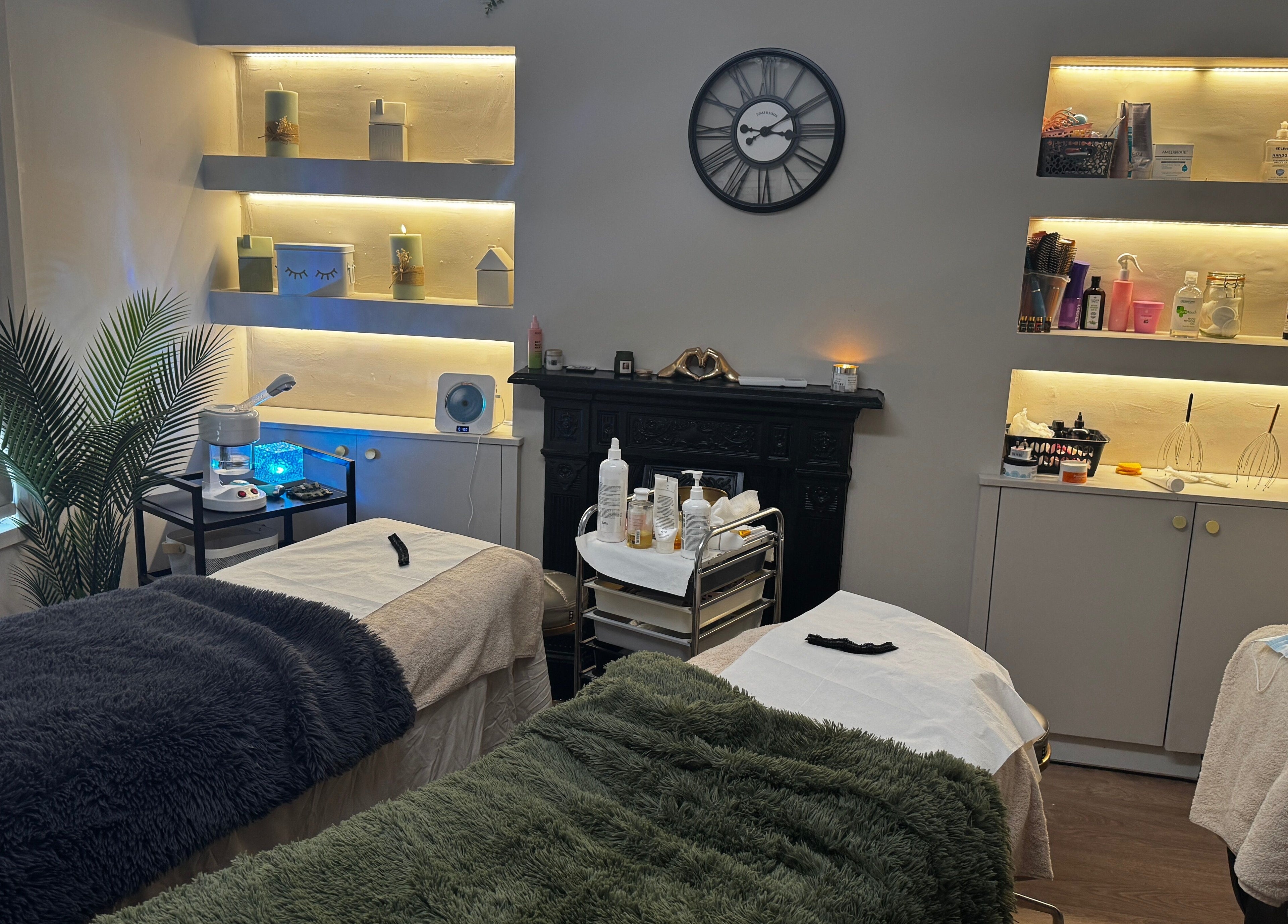 Calming treatment room at Aesthetically Yours, Poynton, England, GB with cozy beds and ambient lighting.
