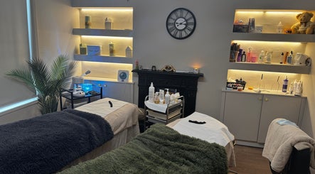 Calming treatment room at Aesthetically Yours, Poynton, England, GB with cozy beds and ambient lighting.