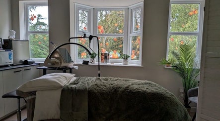 Relaxing treatment room at Aesthetically Yours in Poynton, England, GB with serene decor and natural light.