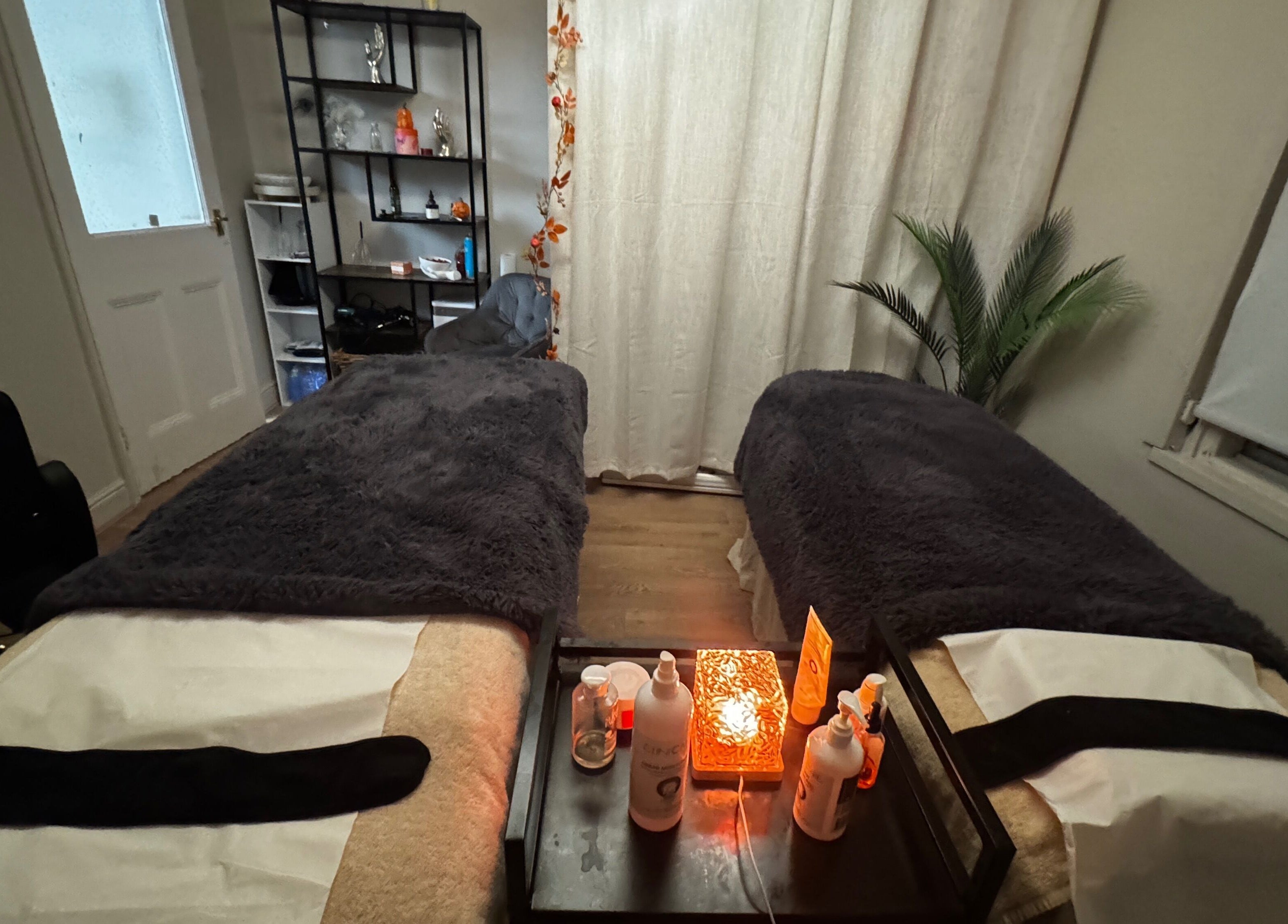 Relaxing massage room at Aesthetically Yours in Poynton, England. Cozy beds and calming decor.