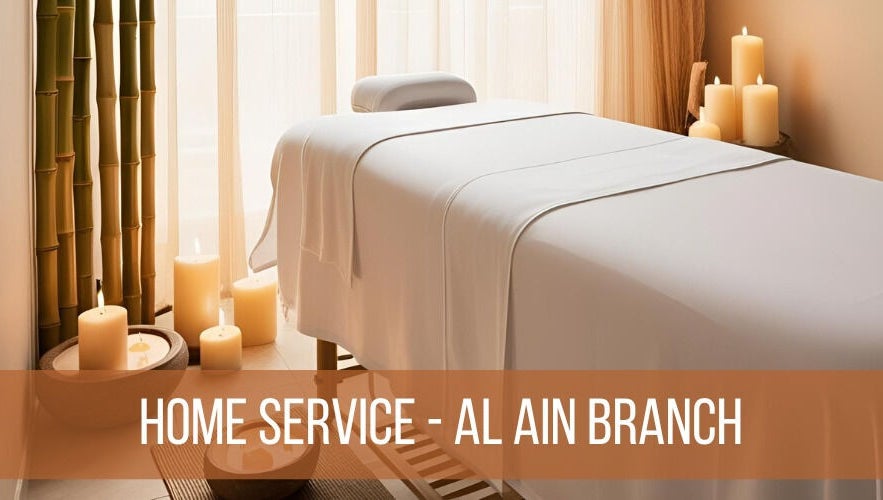 Relaxing massage table setup at La Poupee Home Service - Al Ain in Al Ain, AE, with candles and bamboo decor.