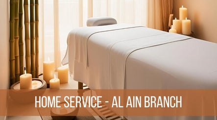 Relaxing massage table setup at La Poupee Home Service - Al Ain in Al Ain, AE, with candles and bamboo decor.