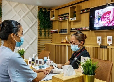 Nail technician at La Poupee Home Service - Abu Dhabi giving manicure in Abu Dhabi, Abu Dhabi, AE.