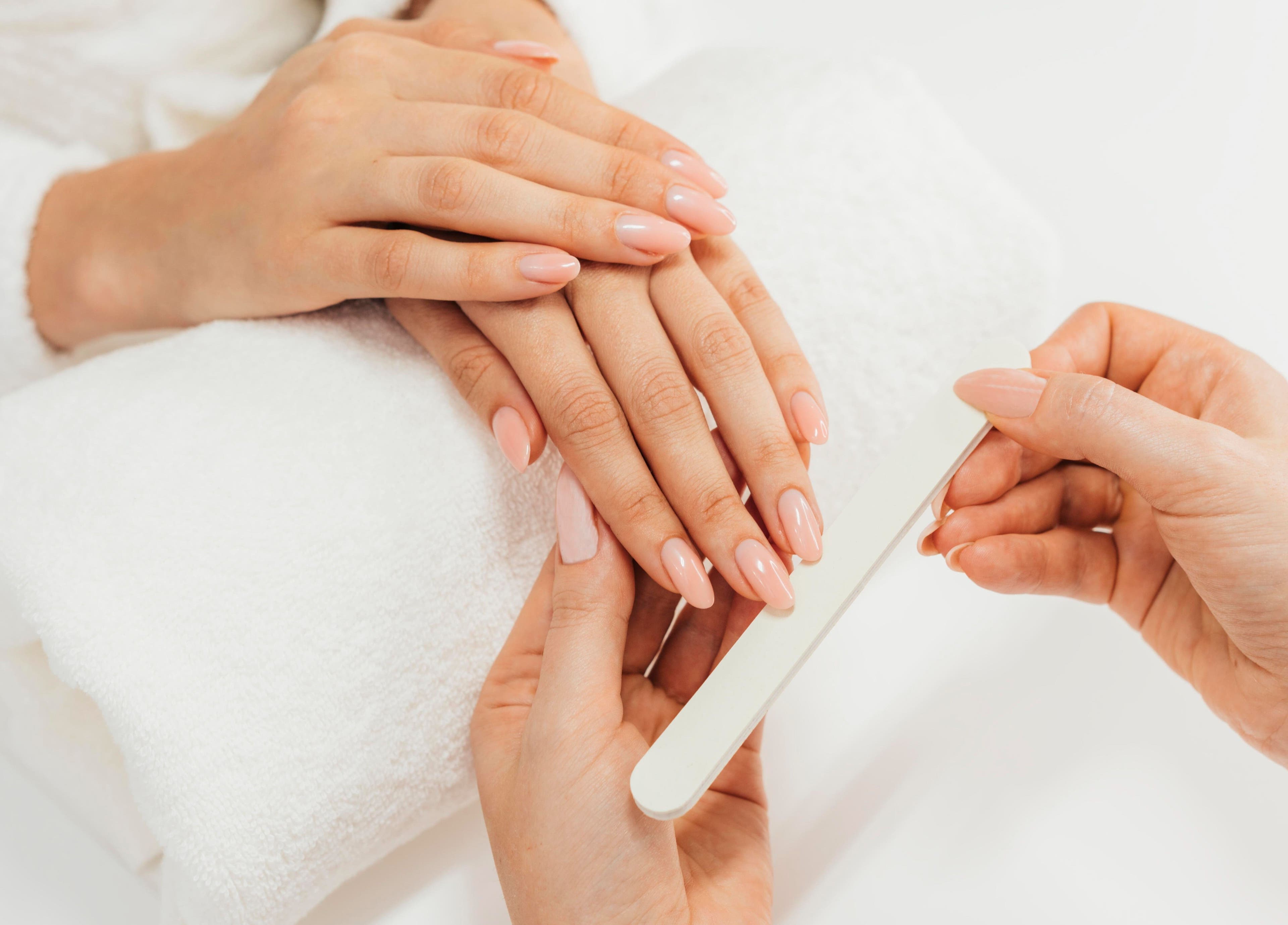 Manicure session at La Poupee Home Service - Abu Dhabi, enhancing nails with precision. Located in Abu Dhabi, AE.