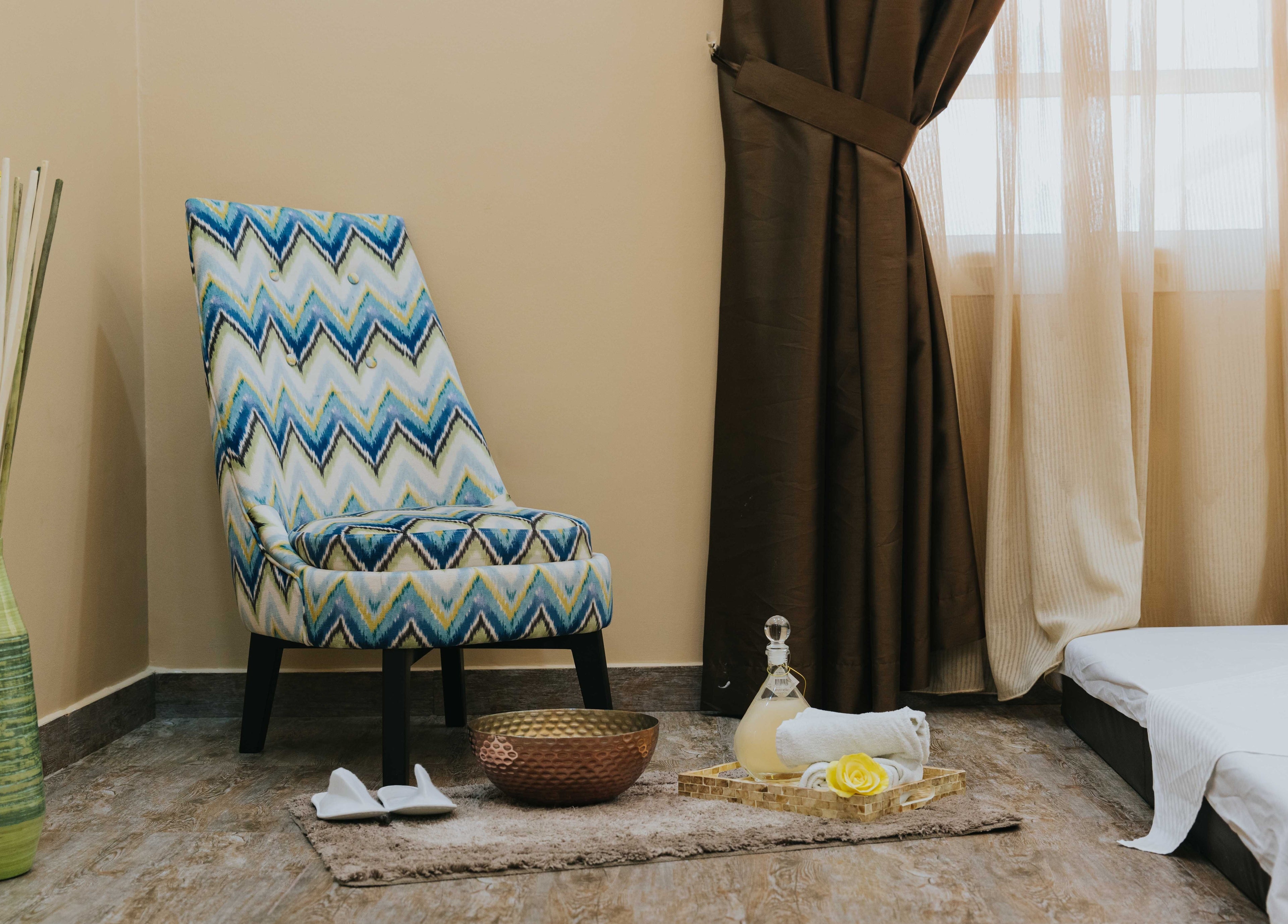 Inviting relaxation corner at La Poupee Home Service - Al Ain, featuring plush chair, elegant decor in Al Ain, AE.