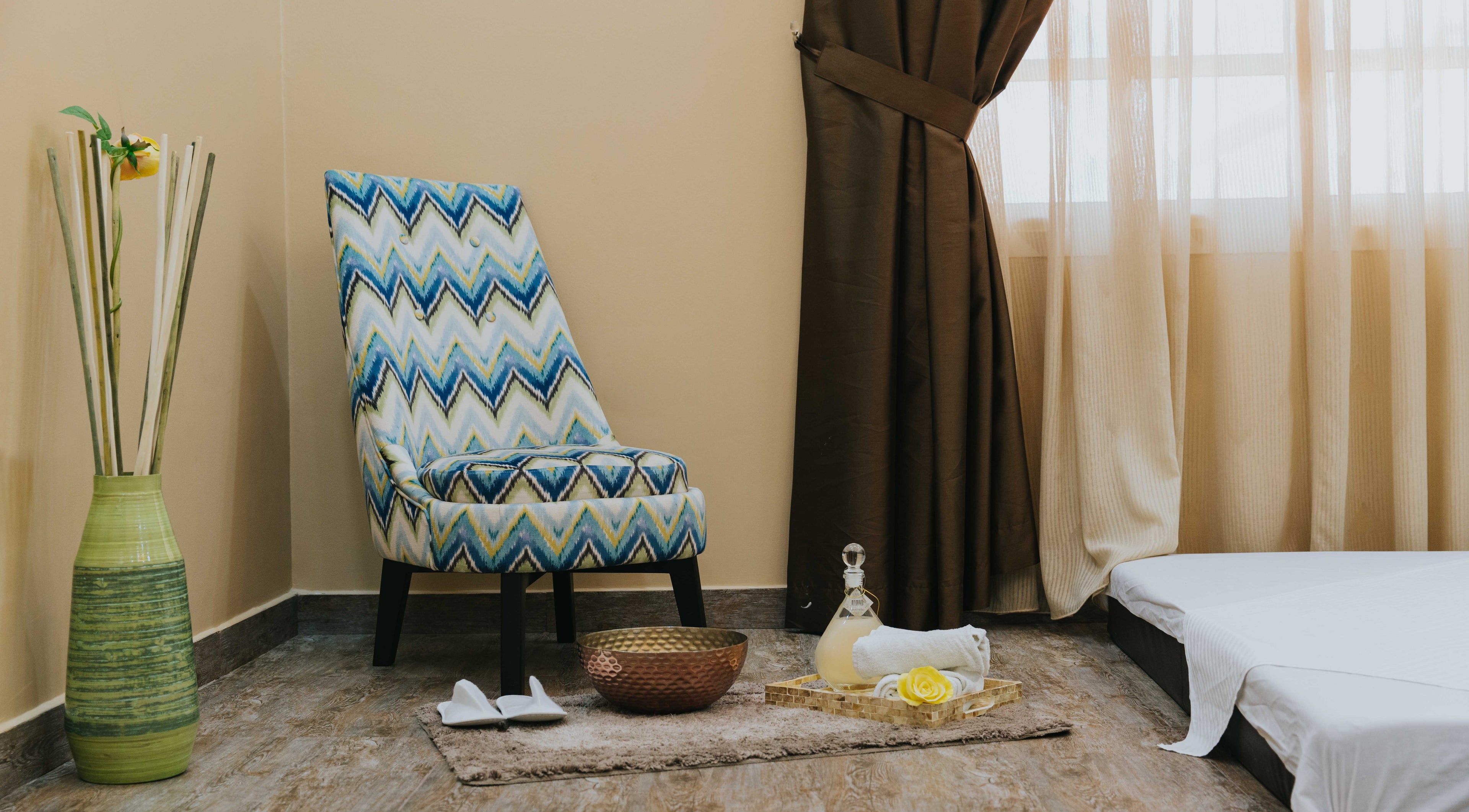 Inviting relaxation corner at La Poupee Home Service - Al Ain, featuring plush chair, elegant decor in Al Ain, AE.