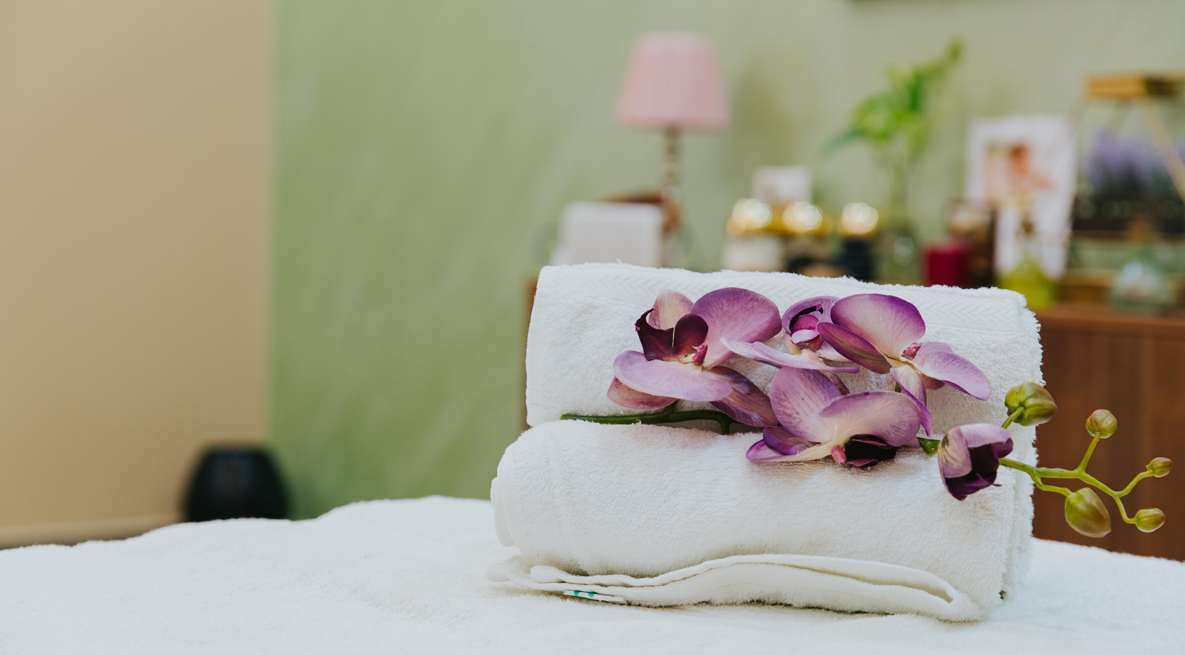 Luxurious spa setting at La Poupee Home Service - Al Ain, featuring fresh orchids in Al Ain, AE.