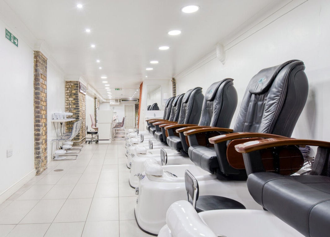 Spacious pedicure area at The Nail Lounge, London, England, GB, featuring modern chairs and soothing ambiance.