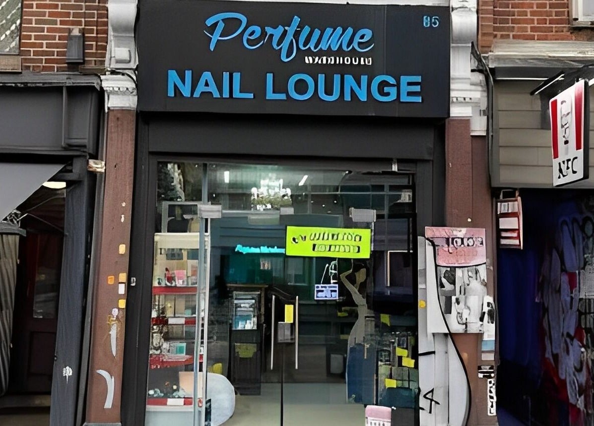 The Nail Lounge entrance in London, England, GB, featuring a stylish glass storefront and modern signage.