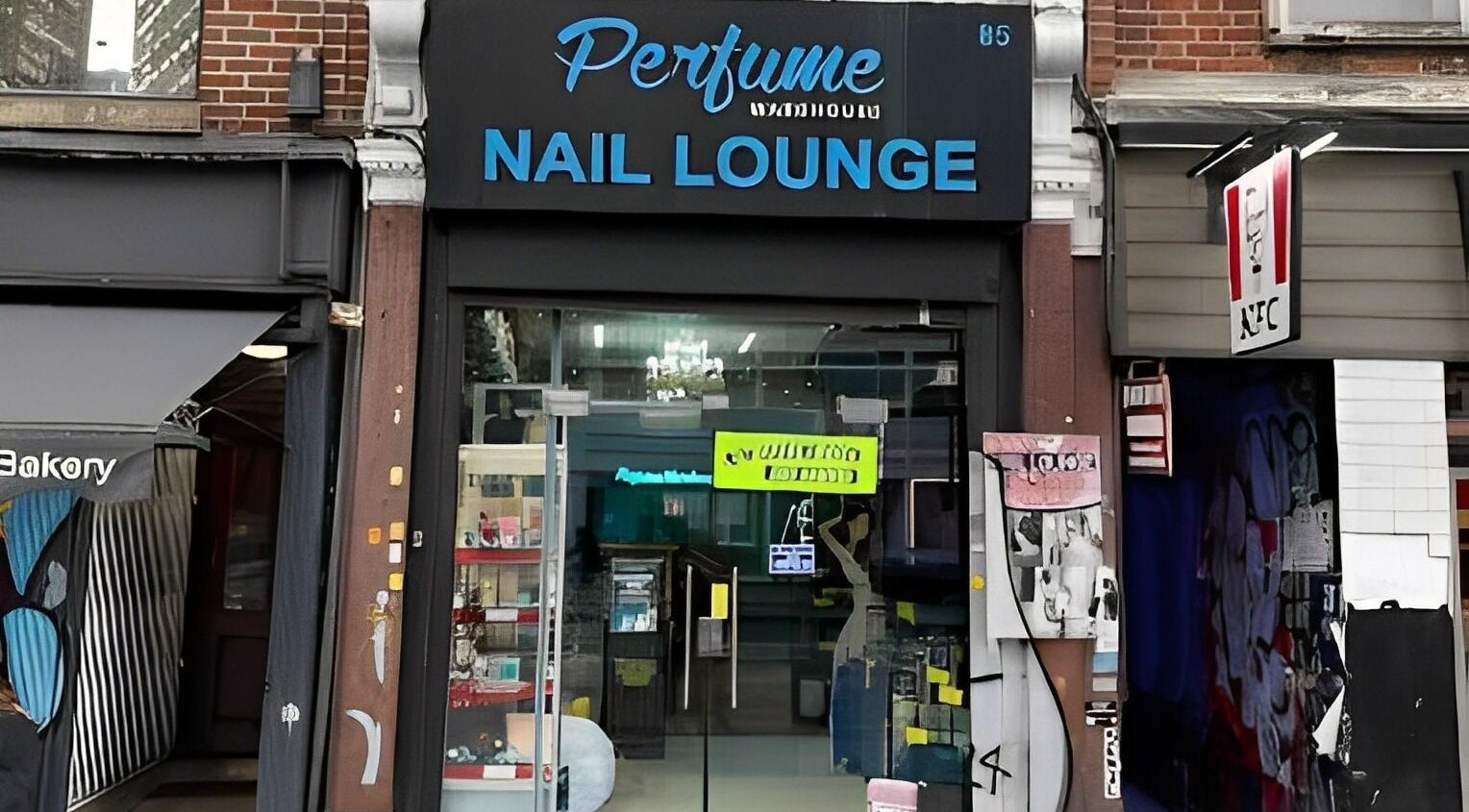 The Nail Lounge entrance in London, England, GB, featuring a stylish glass storefront and modern signage.