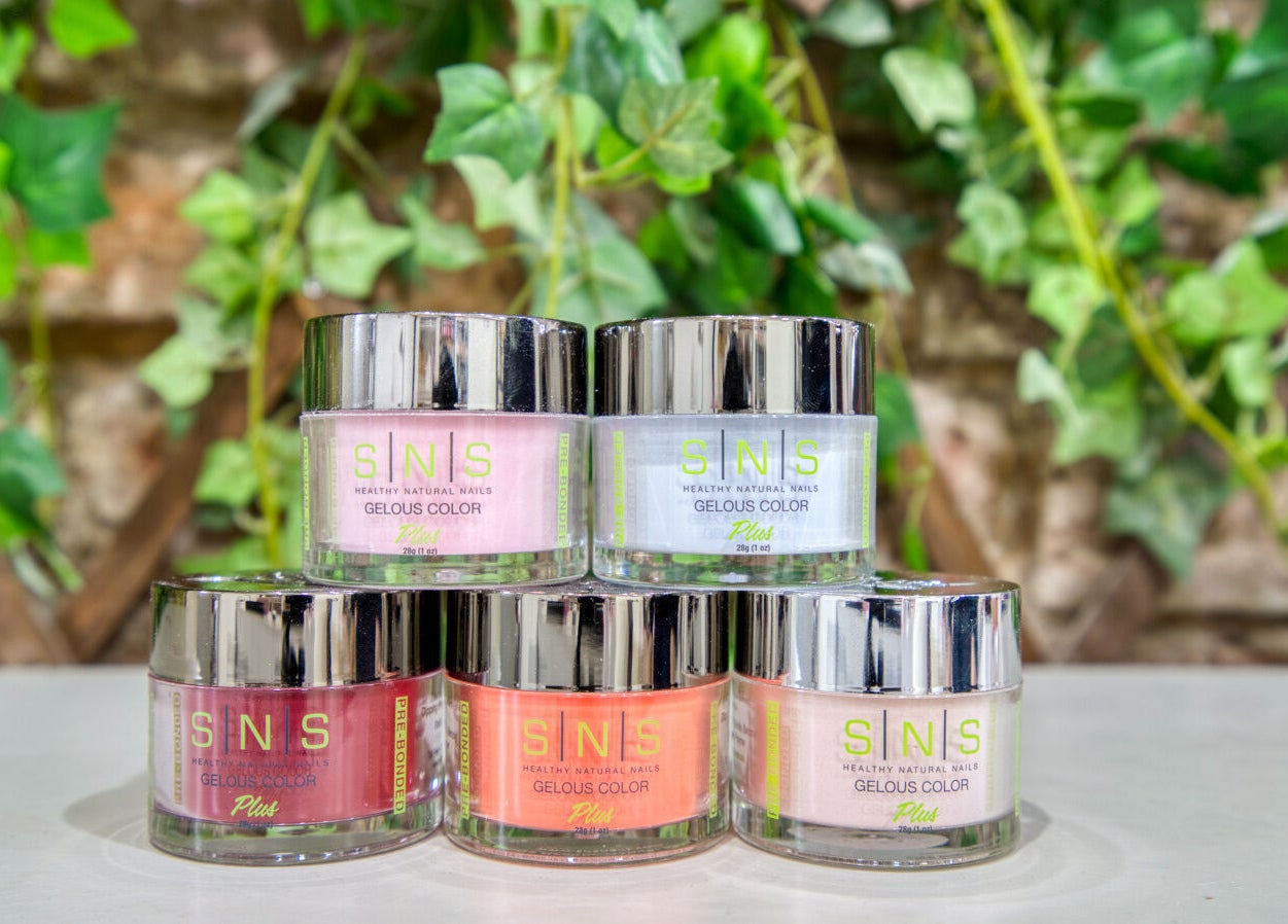 Colorful SNS nail polish jars at The Nail Lounge, London, England, GB. Enhance nails with vibrant hues.