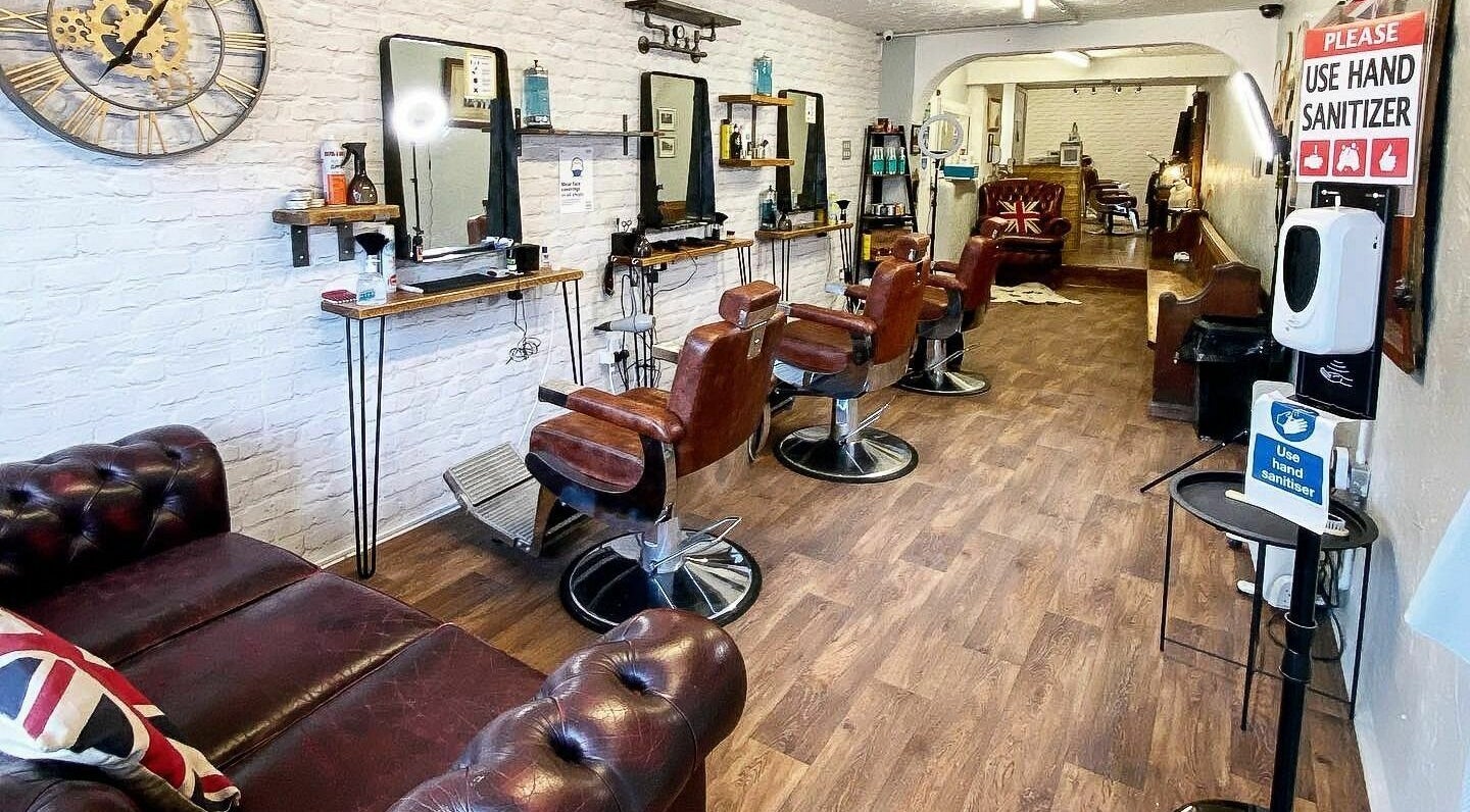 Inside Big Reds Barbers in Stockton-on-Tees, England, GB, showcasing vintage leather chairs and rustic decor.