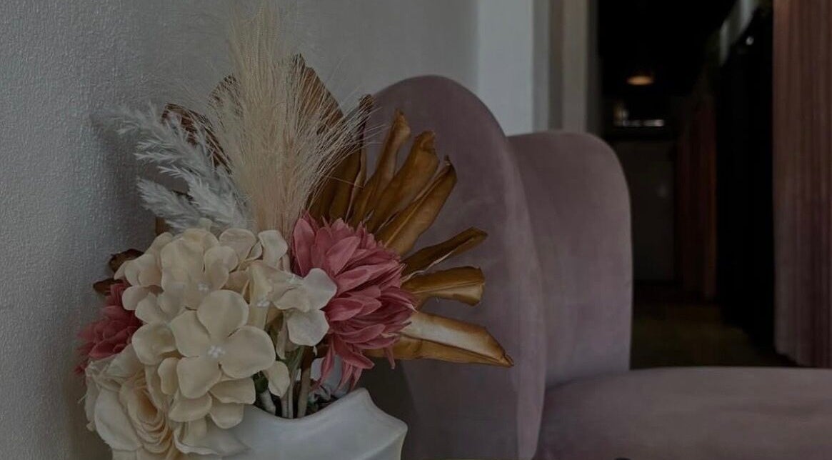 Elegant seating area with floral decor at De Luxe Beauty Therapy, Grafton, New South Wales, AU.