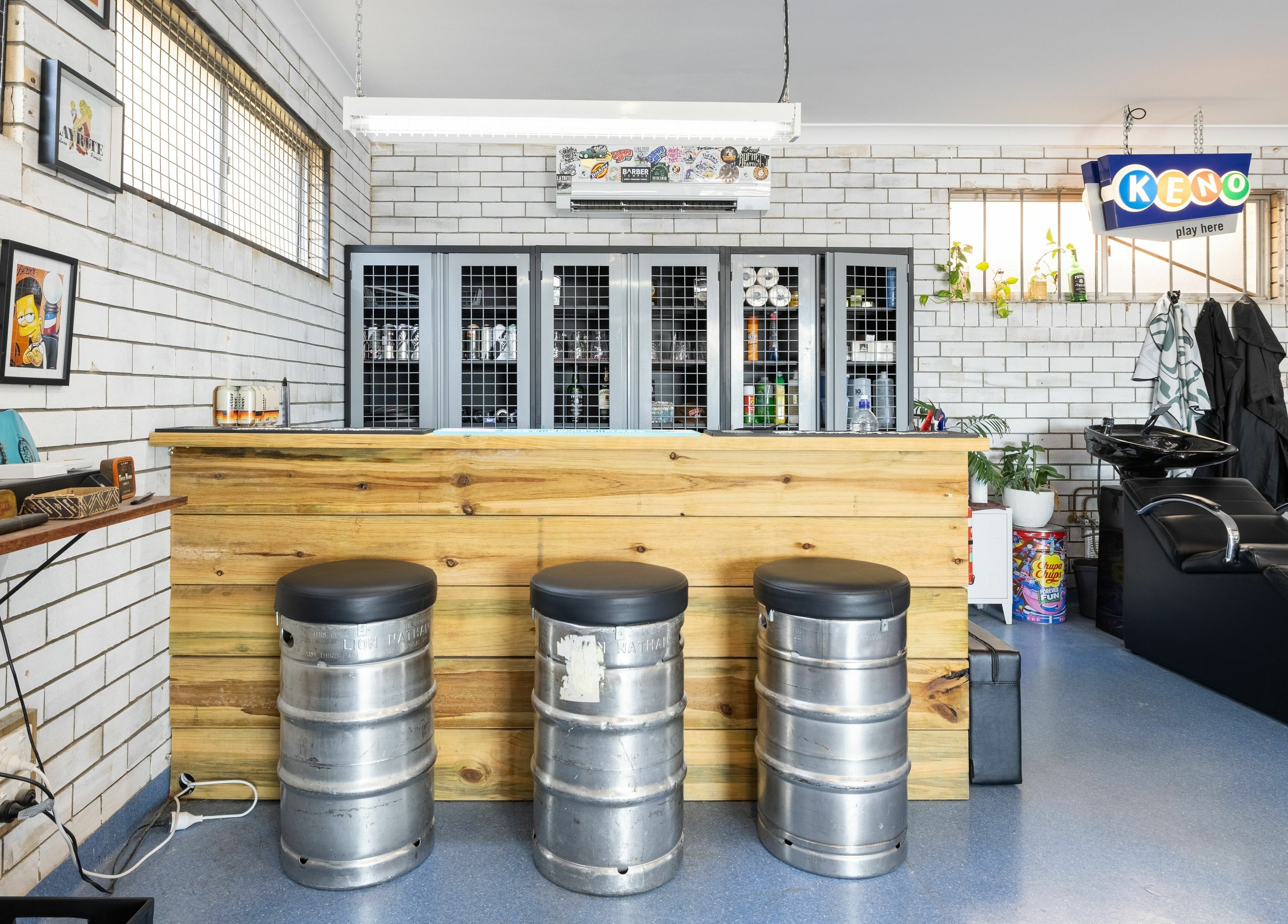 Interior of Grampa Ed, Banora Point, New South Wales with industrial decor and metal stools at the bar.