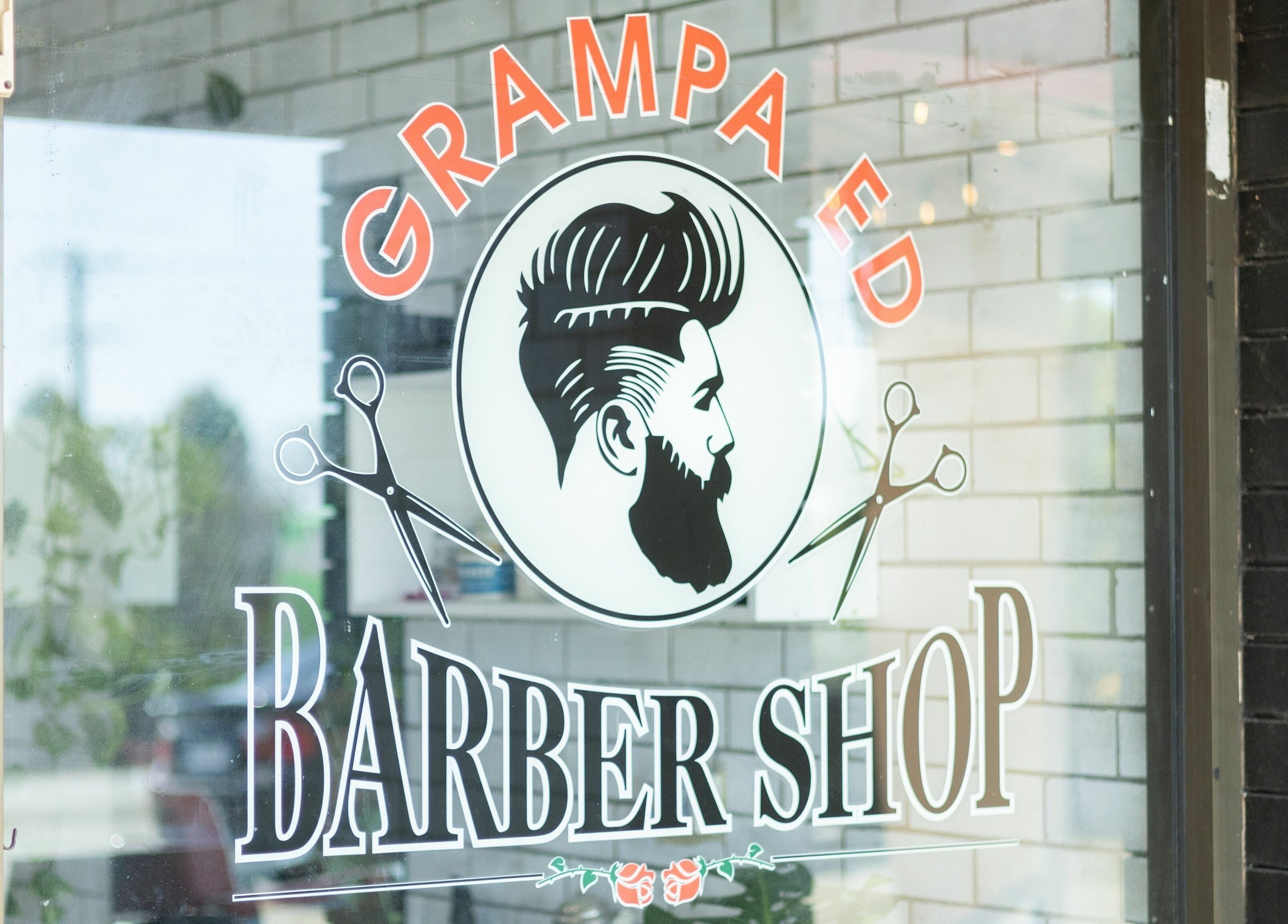 Grampa Ed Barber Shop window in Banora Point, New South Wales, AU, featuring a vintage logo.