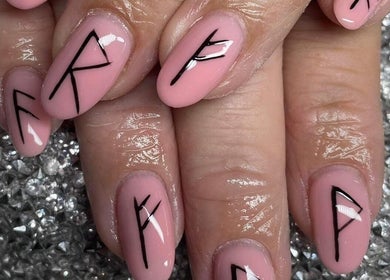 Stylish black rune nail art on pink polish at Nailcreations, Dunfermline, Scotland, GB.