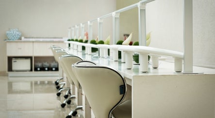 Chic manicure stations at Society 1840 in Johannesburg, Gauteng, ZA, featuring modern decor and plush chairs.