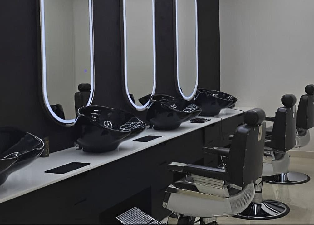 Stylish salon interior at Society 1840, Johannesburg, Gauteng, ZA, featuring black chairs and modern mirrors.