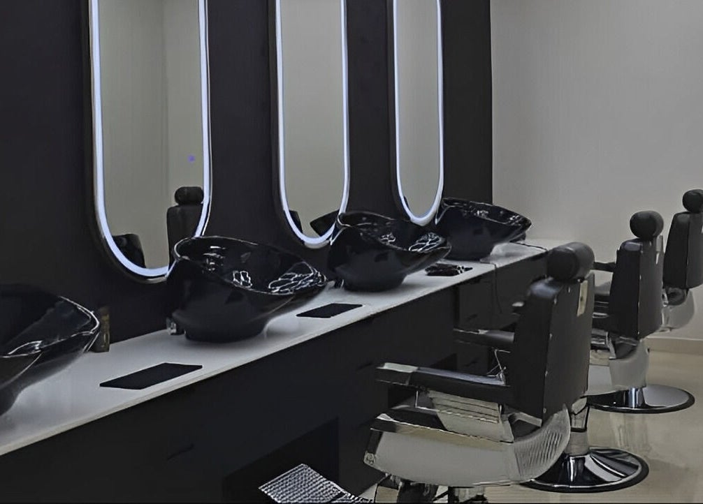 Stylish salon interior at Society 1840, Johannesburg, Gauteng, ZA, featuring black chairs and modern mirrors.