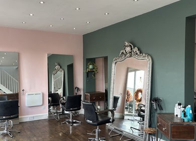 Stylish interior of Tanya at The Hair Boutique in Barrow upon Soar, England, GB with plush chairs and large mirrors.