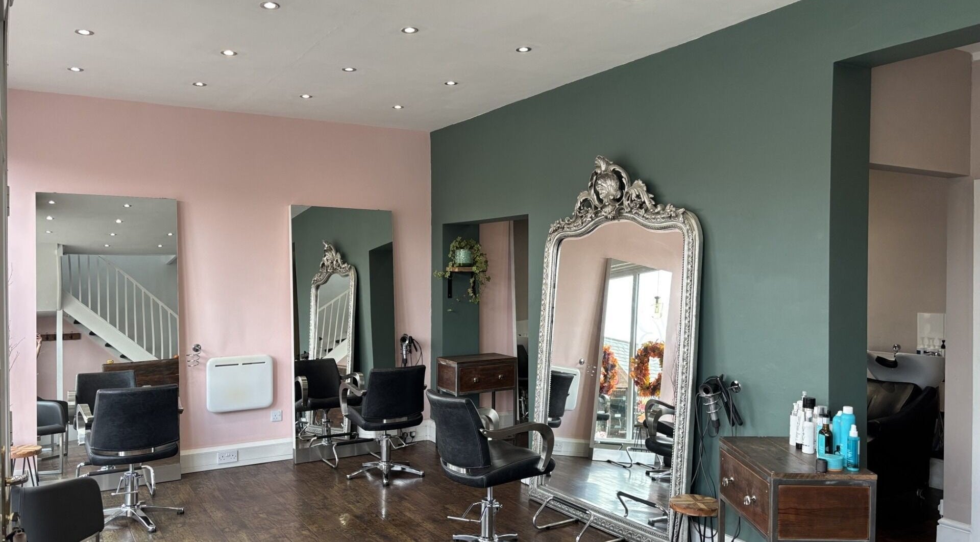 Stylish interior of Tanya at The Hair Boutique in Barrow upon Soar, England, GB with plush chairs and large mirrors.