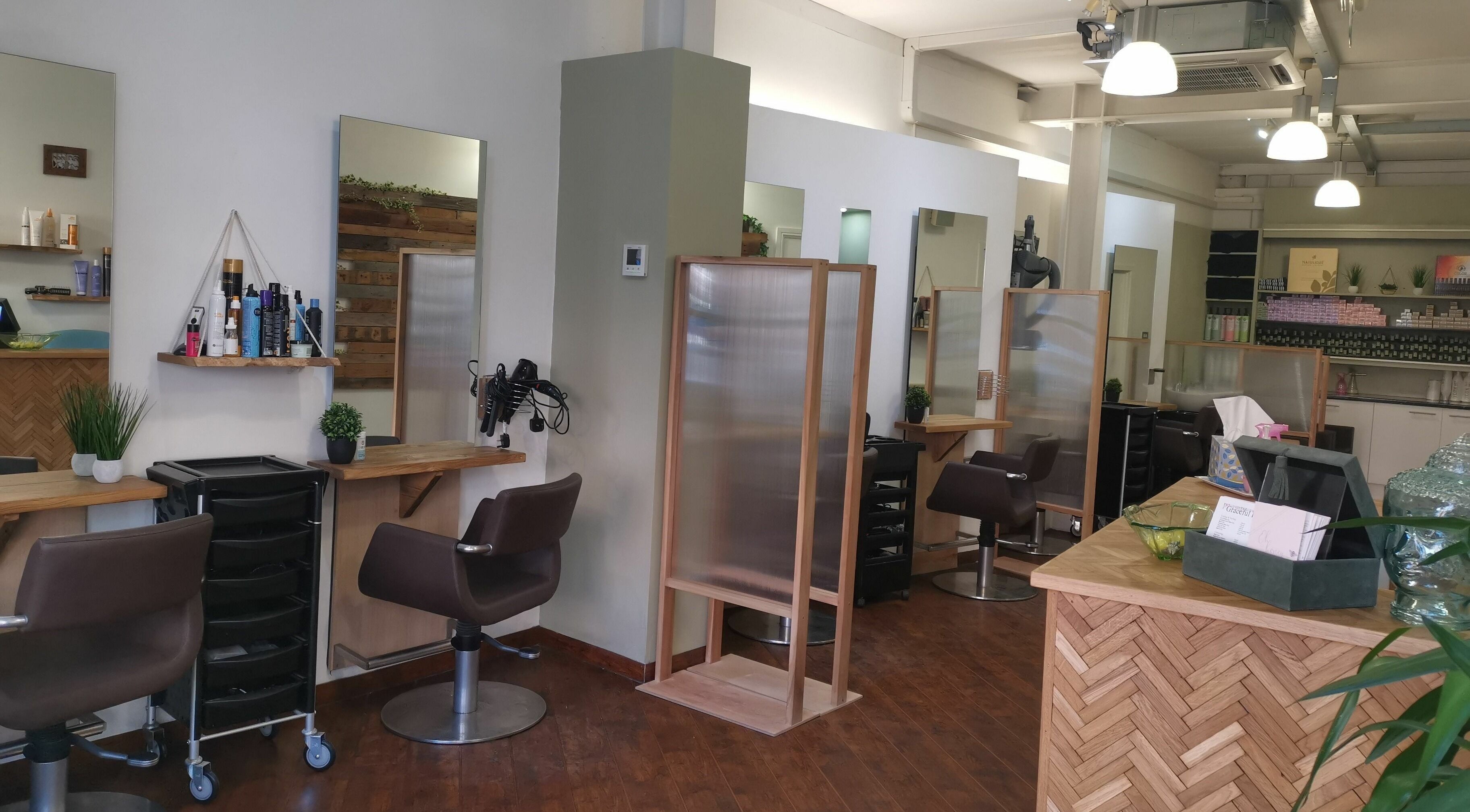 Modern salon interior at Graceful Hair in Ipswich, England, GB, featuring styling stations and contemporary decor.
