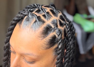 Close-up of braided hairstyle at Loc N' Hold, Market Hill, Saint George, BB, showcasing intricate design.