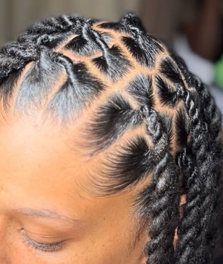 Close-up of braided hairstyle at Loc N' Hold, Market Hill, Saint George, BB, showcasing intricate design.