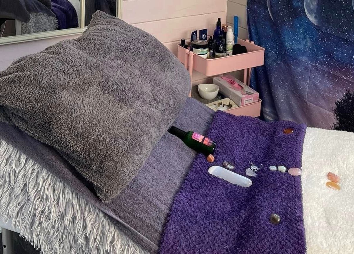 Cozy therapy bed at Twilight Garden Complementary Therapies, Chelmsford, England, GB, adorned with crystals.