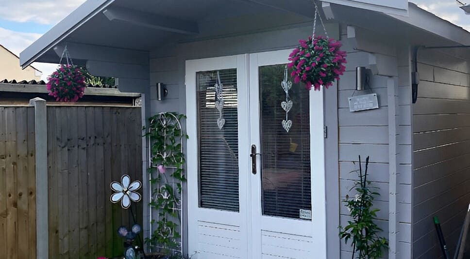 Cozy exterior at Twilight Garden Complementary Therapies, Chelmsford, England, GB, featuring vibrant hanging flowers.