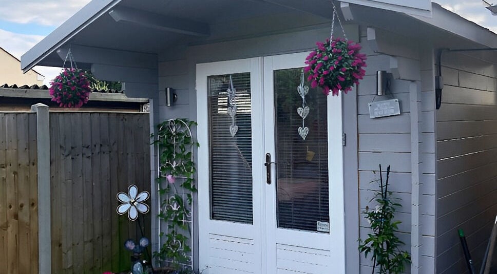 Cozy exterior at Twilight Garden Complementary Therapies, Chelmsford, England, GB, featuring vibrant hanging flowers.