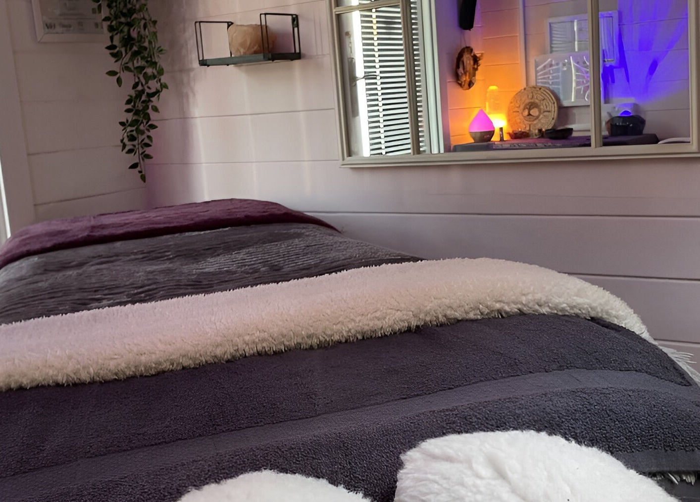 Cozy massage room at Twilight Garden Complementary Therapies, Chelmsford, England, GB, with soft lighting and decor.